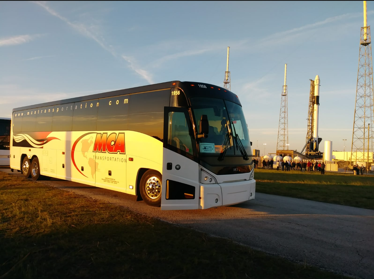 MCA Transportation motorcoach at Kennedy Space Center launch pad at golden hour