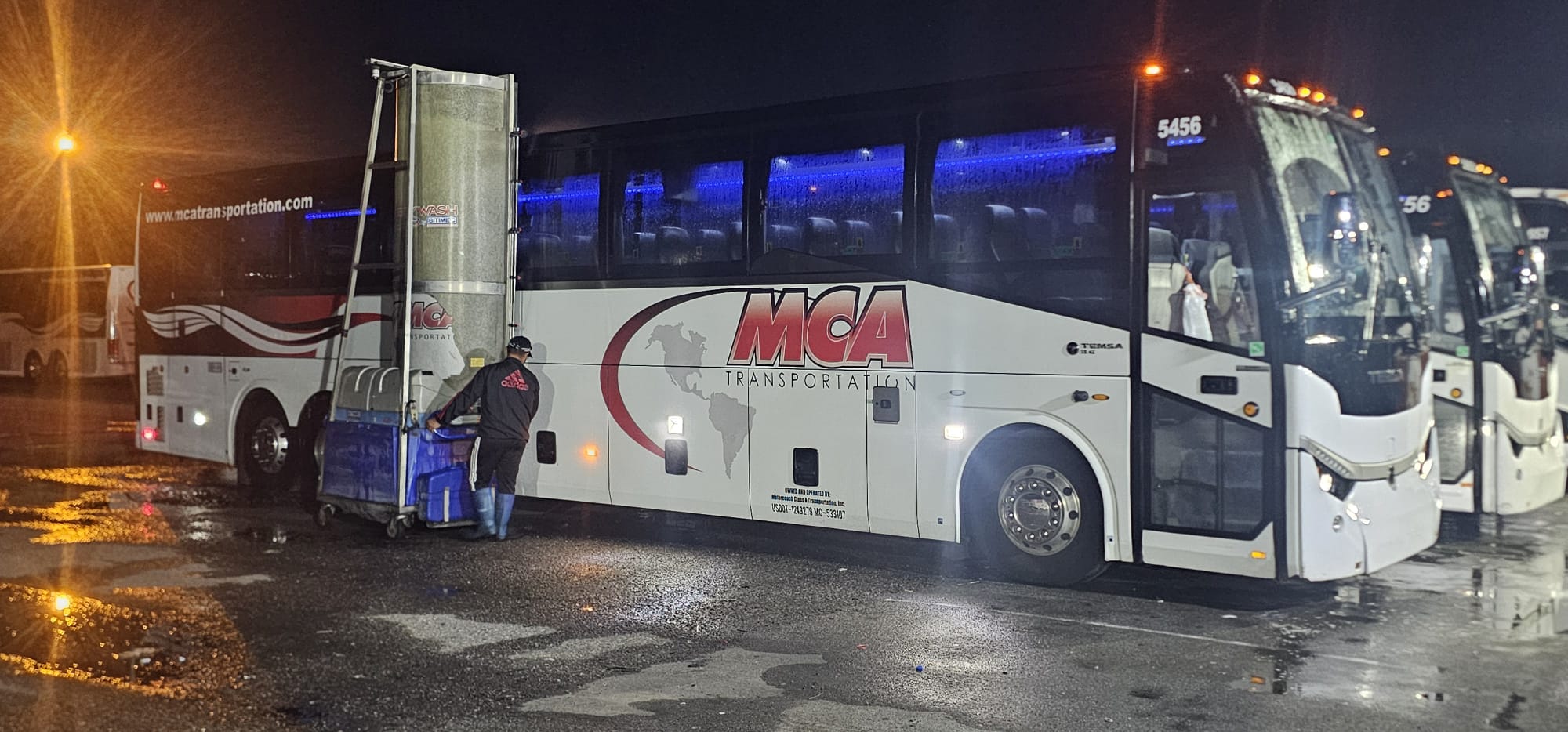 MCA Transportation overnight crew washing a branded motorcoach