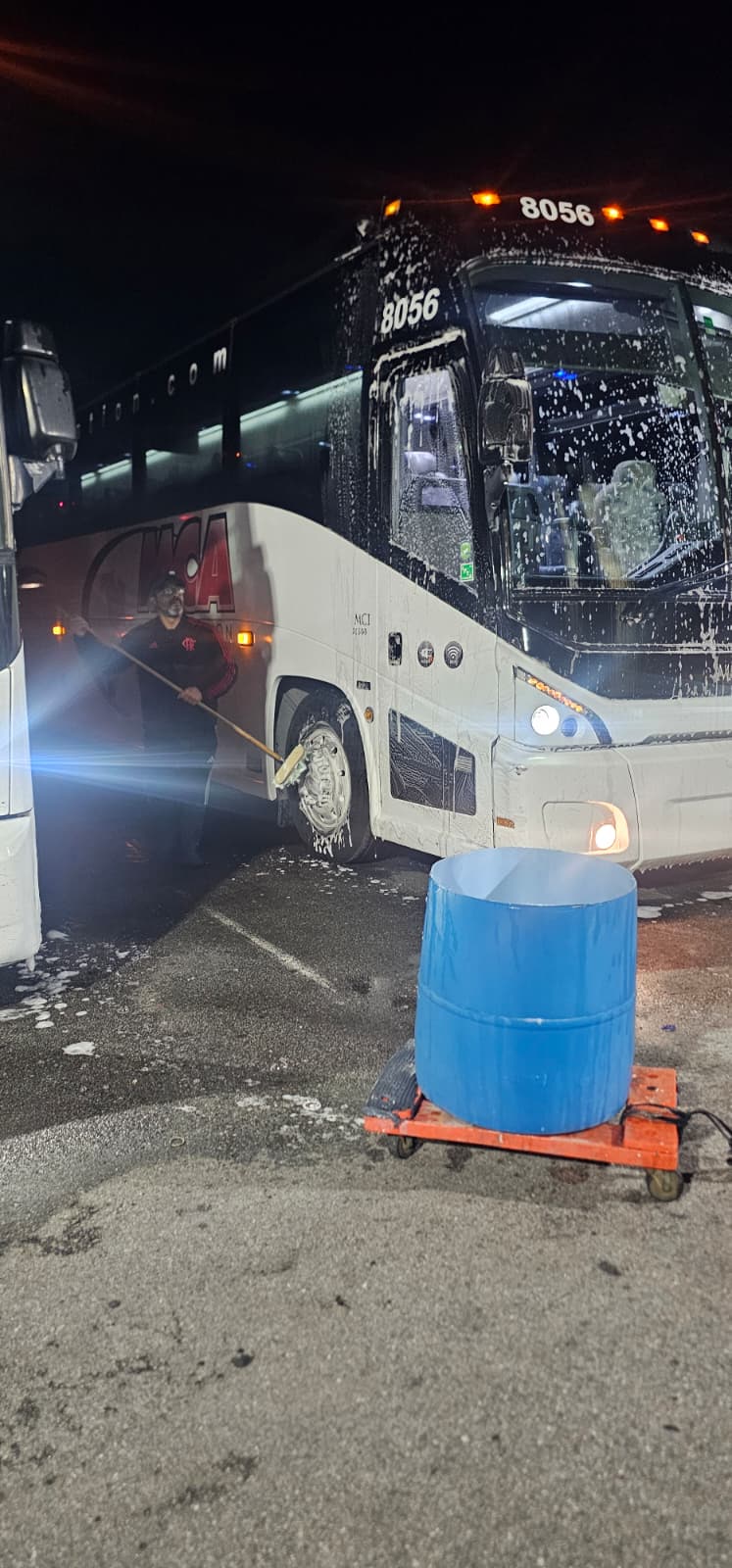 MCA Transportation overnight crew washing a branded motorcoach