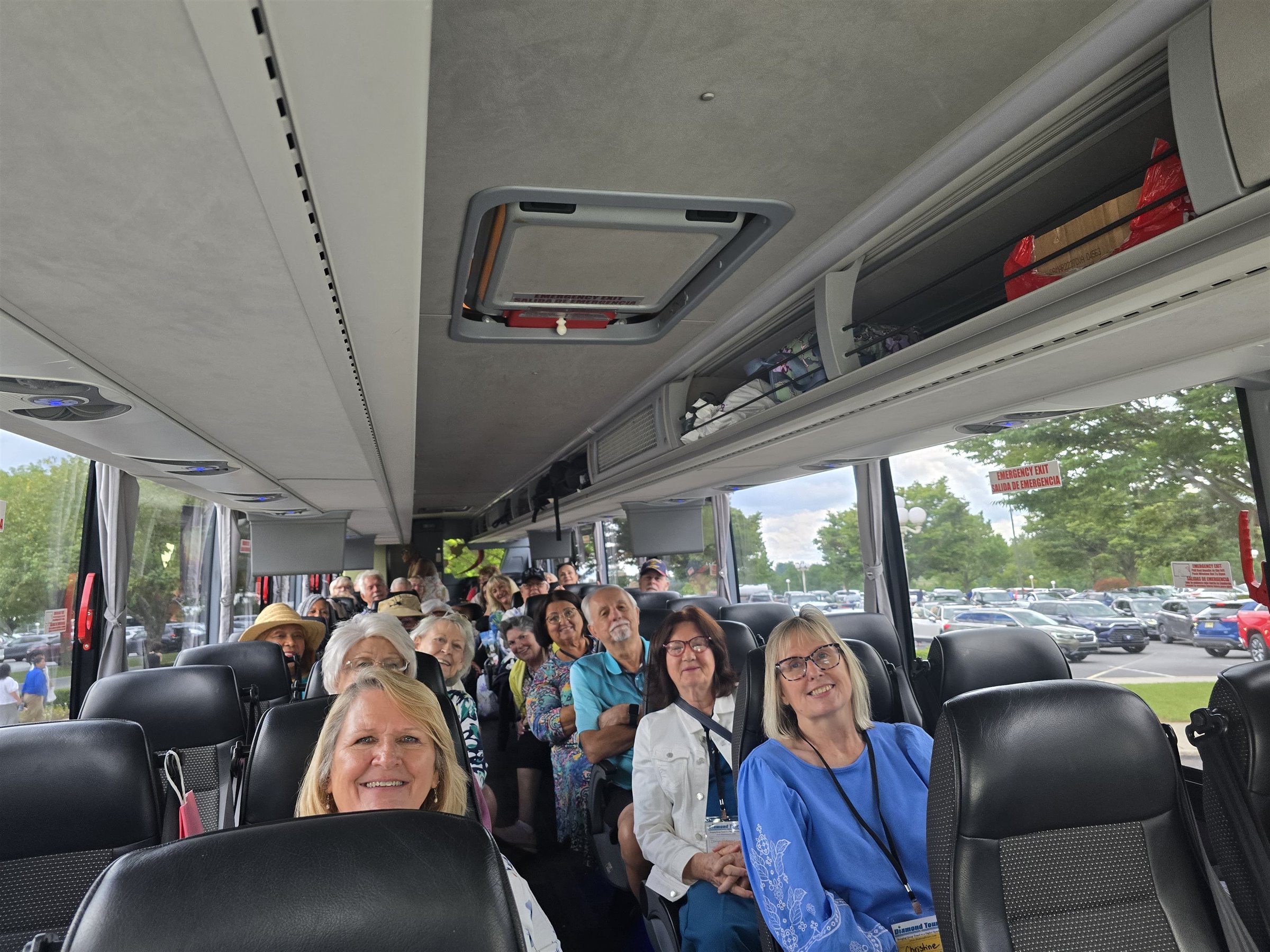 Senior travel group seated inside an MCA Transportation motorcoach
